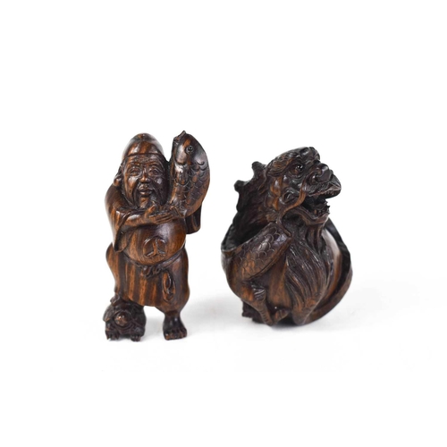 6 - Two wooden Netsuke, late Edo period, 19th century, one in the form of a dragon, the other a man carr... 