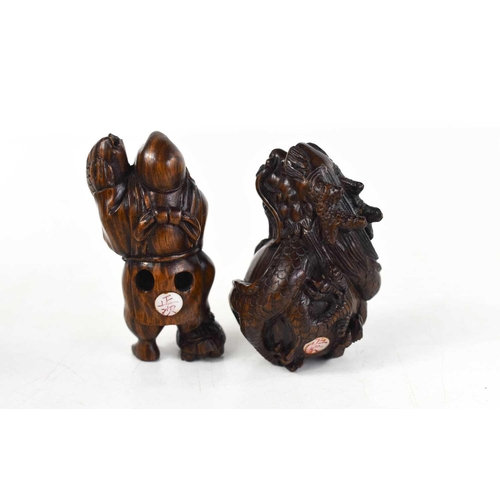 6 - Two wooden Netsuke, late Edo period, 19th century, one in the form of a dragon, the other a man carr... 