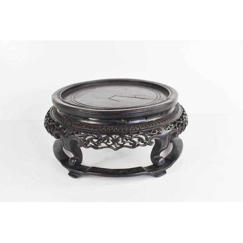 65 - An early Chinese carved stand, of circular form, circa 1750, the sides pierced and carved with folia... 