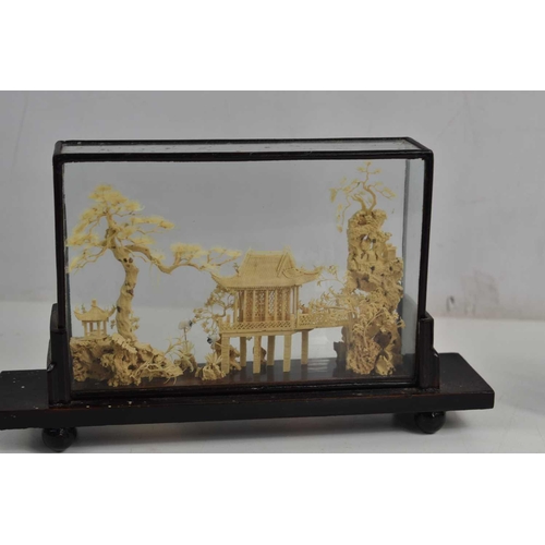 72 - Two Chinese cork dioramas depicting a pavilion and trees, both in a glazed case, the largest measuri... 