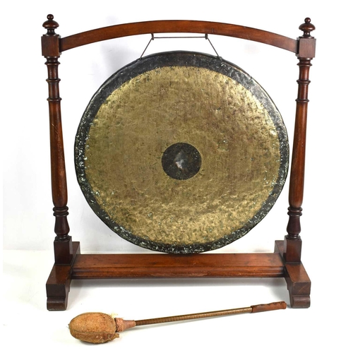 90 - A 19th century Chinese bronze dinner gong suspended in a turned mahogany frame, the hand beaten bron... 