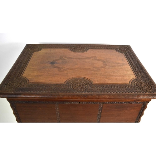 93 - An Indonesian hardwood casket on stand with intricately carved borders.