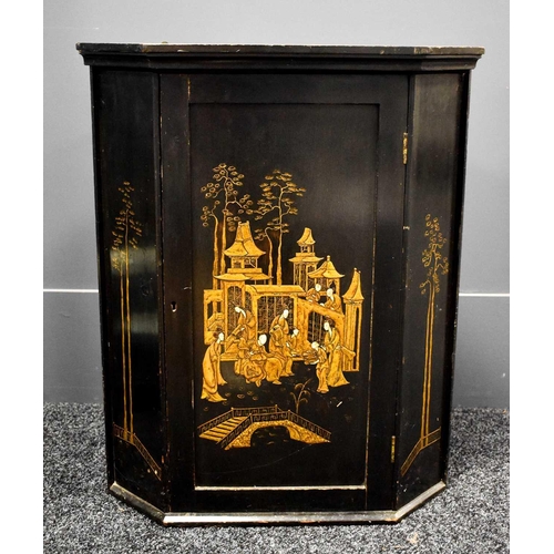 95 - A 19th century black lacquered Chinoiserie decorated corner cupboard, the single door depicting a co... 