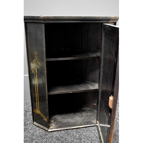 95 - A 19th century black lacquered Chinoiserie decorated corner cupboard, the single door depicting a co... 