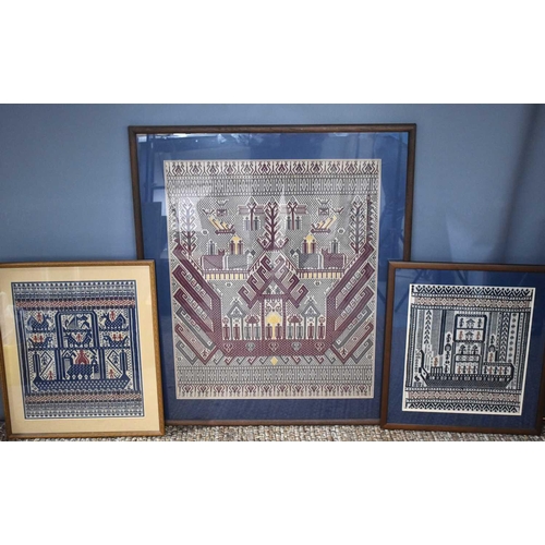 97 - Three framed and glazed hand woven Indonesian tapestry panels, the largest measuring 63cm 76cm.