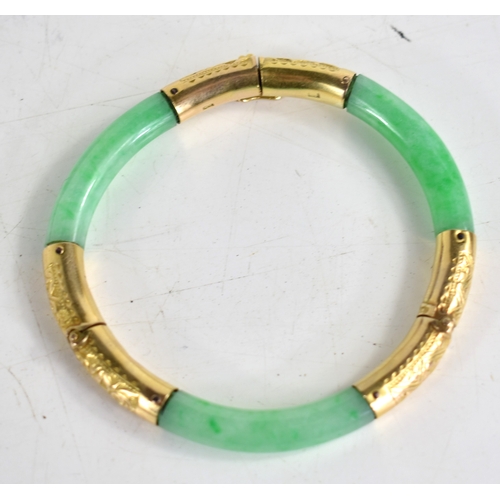 25 - An early 20th century Chinese gold and jade bracelet with articulated hinges made by Wang Hing of Ho... 