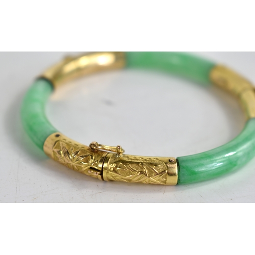 25 - An early 20th century Chinese gold and jade bracelet with articulated hinges made by Wang Hing of Ho... 