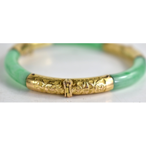 25 - An early 20th century Chinese gold and jade bracelet with articulated hinges made by Wang Hing of Ho... 