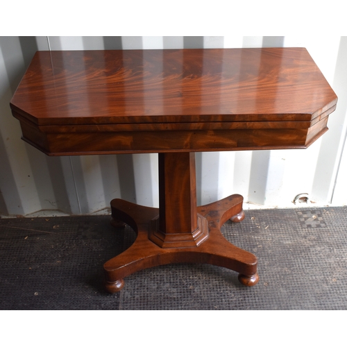 533 - A 19th century mahogany card table with swivel top opening to reveal a well interior, above circular... 