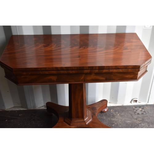 533 - A 19th century mahogany card table with swivel top opening to reveal a well interior, above circular... 