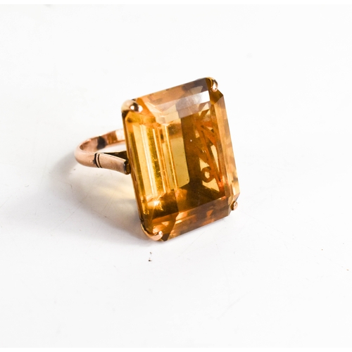 26A - A 14ct gold and yellow quartz ring, the trap cut quartz 41cts, L12.9g, with Raffles Hotel of Singapo... 