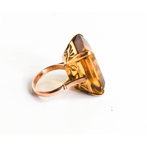 26A - A 14ct gold and yellow quartz ring, the trap cut quartz 41cts, L12.9g, with Raffles Hotel of Singapo... 