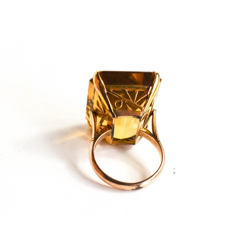 26A - A 14ct gold and yellow quartz ring, the trap cut quartz 41cts, L12.9g, with Raffles Hotel of Singapo... 