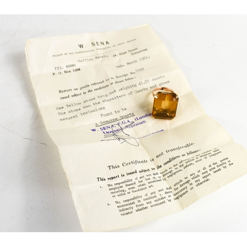 26A - A 14ct gold and yellow quartz ring, the trap cut quartz 41cts, L12.9g, with Raffles Hotel of Singapo... 