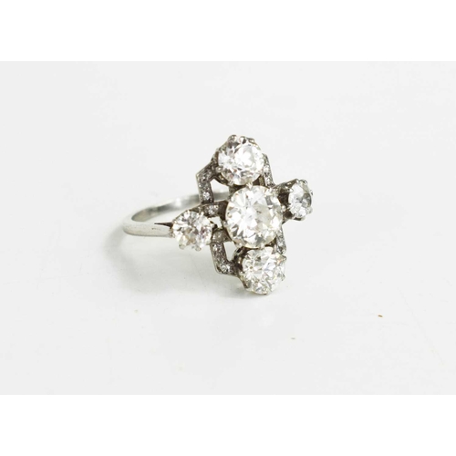 1 - An Art Deco diamond ring, the central brilliant cut diamond approximately 1ct, set in a cross form, ... 