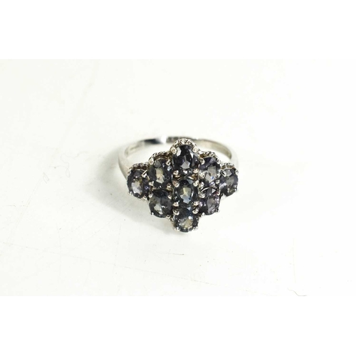 118 - A 9ct white gold and sapphire cluster ring, the oval cut 'colour change' sapphires set in a navette ... 