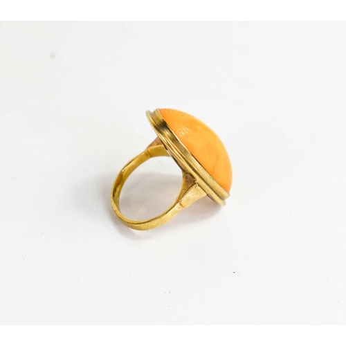 121 - An 8ct gold and butterscotch amber cabochon ring, marked 333 alongside maker AK, size K, 5.3g.