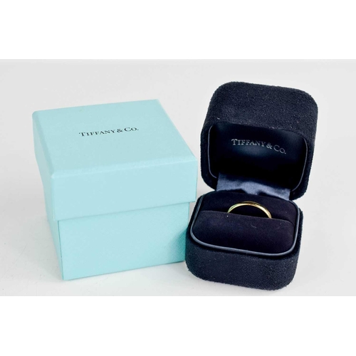 130 - A Tiffany & Co., 18ct gold wedding band, in the original presentation case and outer box, size R, 4g... 