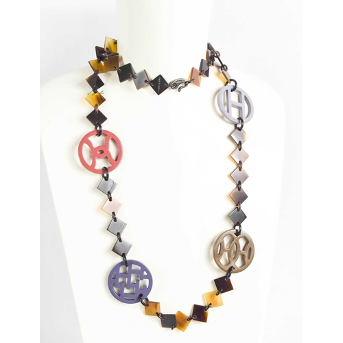 149 - A Hermes Black buffalo horn necklace, with perspex coloured discs, and composed of square form segme... 