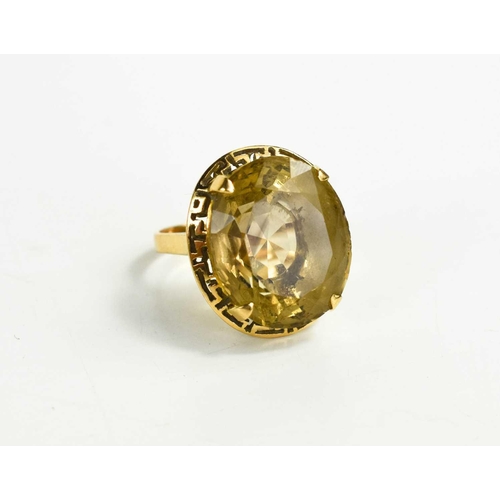 153 - An 18ct gold and pale citrine ring, the oval citrine in four claw setting, with a decorative pierced... 