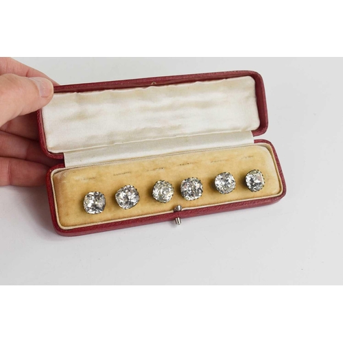 154 - A set of six white metal and paste buttons, in the original red leather presentation case.