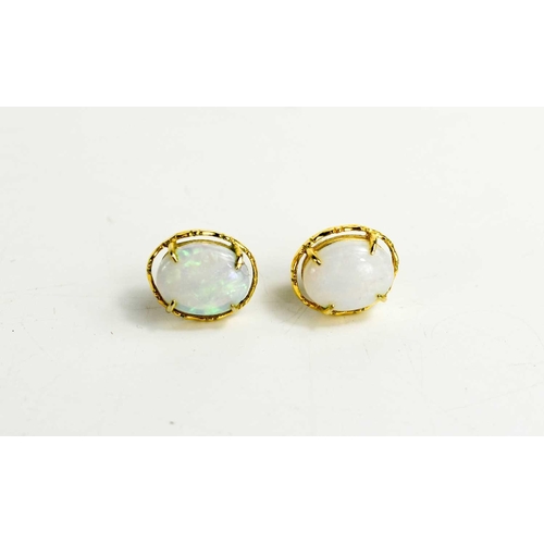 164 - A pair of 14ct gold and opal earrings, the oval opals in four claw setting, butterfly backs, with th... 