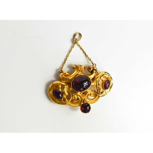 173 - A 19th century gold and garnet cabochon mourning pendant, the scrollwork setting unmarked but testin... 