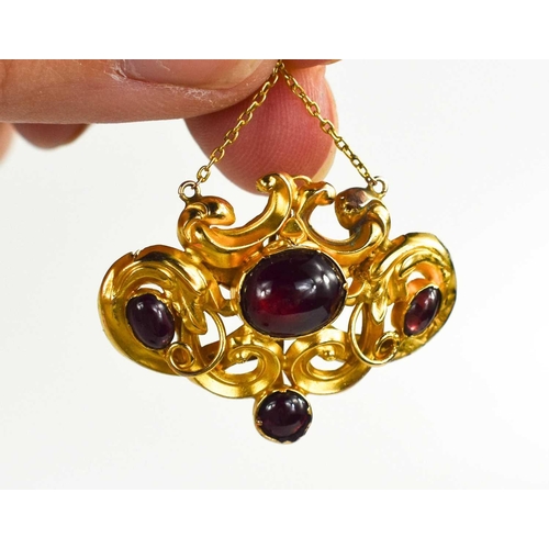 173 - A 19th century gold and garnet cabochon mourning pendant, the scrollwork setting unmarked but testin... 