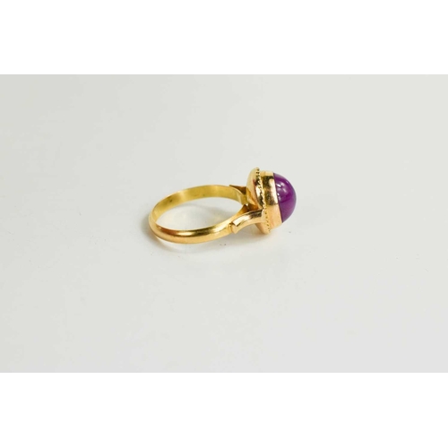 174 - An 18ct gold star ruby ring, the cabochon star ruby in an enclosed setting with ropetwist border, si... 