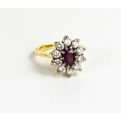 177 - An 18ct gold, ruby and diamond ring, the oval cut ruby bordered by ten brilliant cut diamonds, each ... 