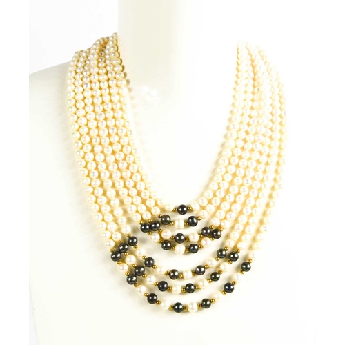 179 - A cultured pearl multi strand necklace, the waterfall form necklace composed of seven strands of pea... 