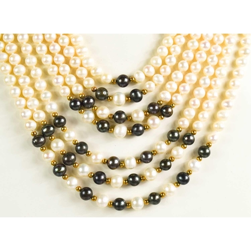 179 - A cultured pearl multi strand necklace, the waterfall form necklace composed of seven strands of pea... 