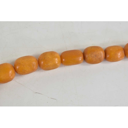 18 - A vintage butterscotch amber beaded necklace, composed of graduated beads on a wire string, 56g. one... 