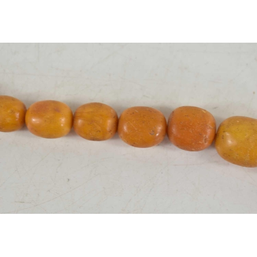 18 - A vintage butterscotch amber beaded necklace, composed of graduated beads on a wire string, 56g. one... 