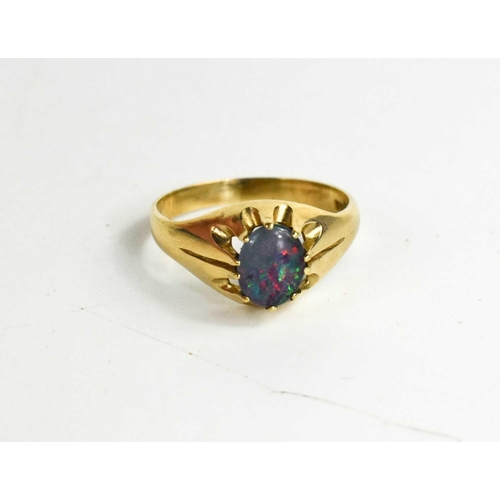 181 - A 9ct gold and opal ring, circa 1970, the oval opal splice in open claw setting, size W, 4.17g.