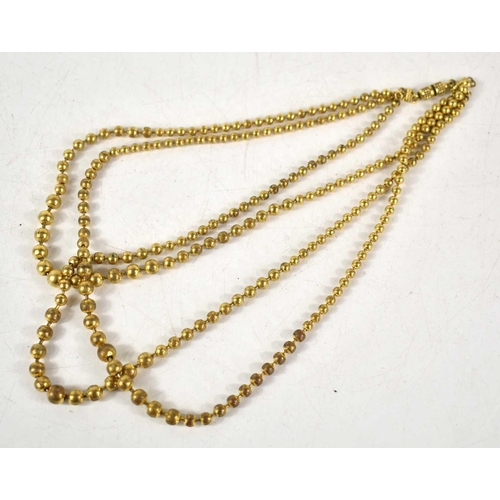 184 - A gilt metal three strand graduated beaded necklace with screw clasp.