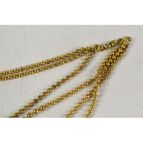 184 - A gilt metal three strand graduated beaded necklace with screw clasp.