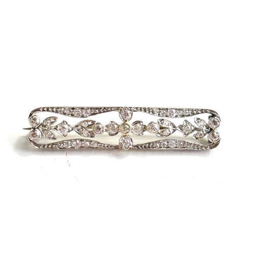 19 - An Art Deco platinum and diamond bar brooch, the diamonds set within a floral stylised tablet settin... 