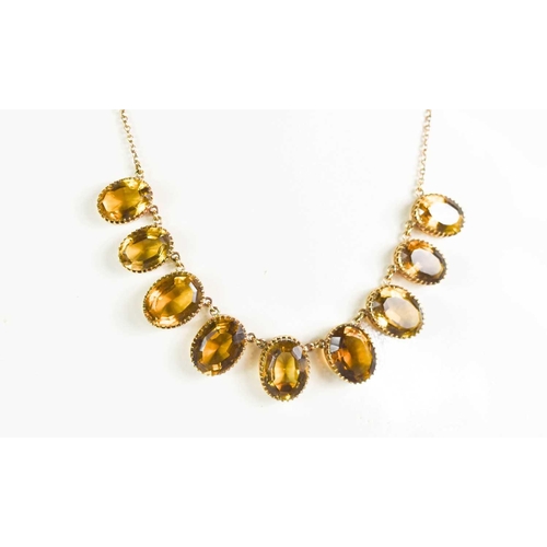 194 - A 9ct gold and citrine necklace, each oval cut citrine in a multi claw open back setting and of grad... 