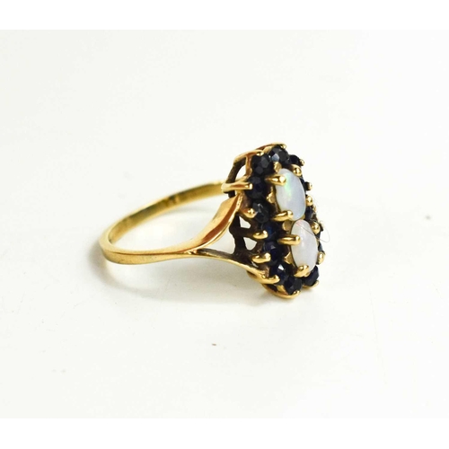 197 - A 9ct gold, opal and sapphire ring, the two oval opals bordered by brilliant cut sapphires and V-cut... 