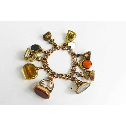 199 - A 9ct gold charm bracelet, with heart form lock clasp, a 9ct gold and agate swivel fob, a citrine an... 