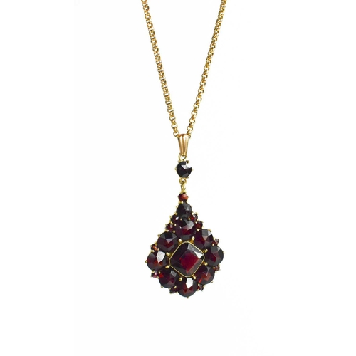 20 - A 9ct gold and garnet pendant necklace, with a central cushion cut garnet bordered by rose cut garne... 