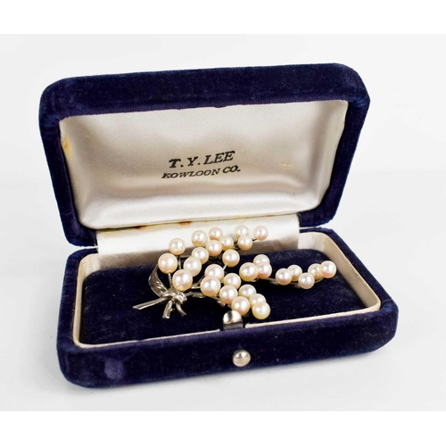 207 - A sterling silver and pearl brooch, in the original presentation box for T Y Lee Kowloon Co., the br... 