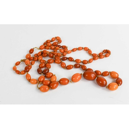 22 - A vintage butterscotch amber necklace, composed of oval graduated amber beads, 32.1g.