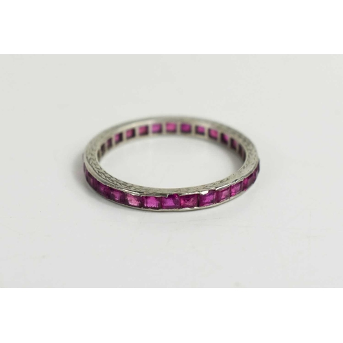 230 - A white gold (unmarked but testing as at least 9ct gold) and pink sapphire eternity ring, size T, 2.... 