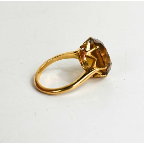 233 - A 9ct gold and citrine ring, the brilliant cut citrine approximately 6cts, in a six claw setting, si... 