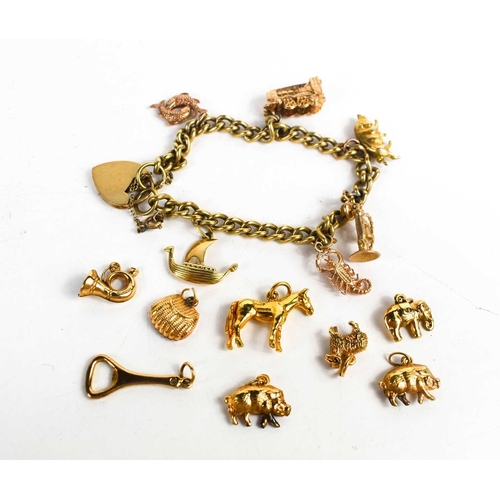 243 - A 9ct gold charm bracelet,with a heart form clasp and safety chain, with some additional loose 9ct g... 