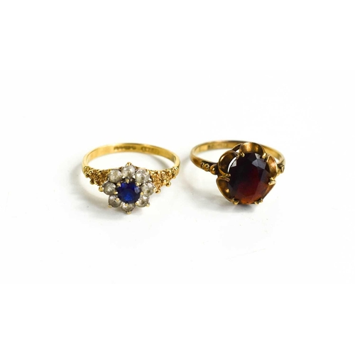 25 - Two 9ct gold rings, one set with an oval cut garnet, size O, the other set with paste in a flowerhea... 