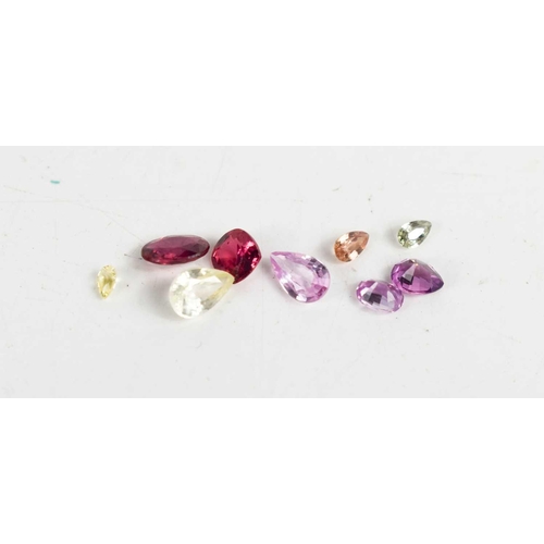 271 - A group of loose gemstones, to include pink sapphire, ruby, topaz and various other examples.