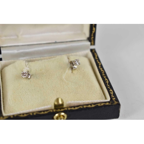 274 - A pair of 18ct gold and diamond earrings, 1.1g, with original case.